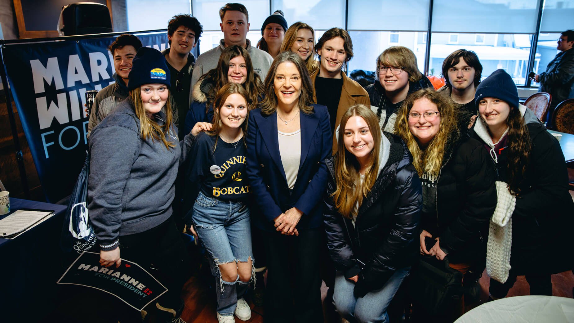 Quinnipiac students take a photo with presidential candidate Marianne Williamson.