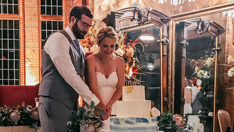 Matthew Freund ’13 and Christine Fetzer ’13 cut their three-tier wedding cake