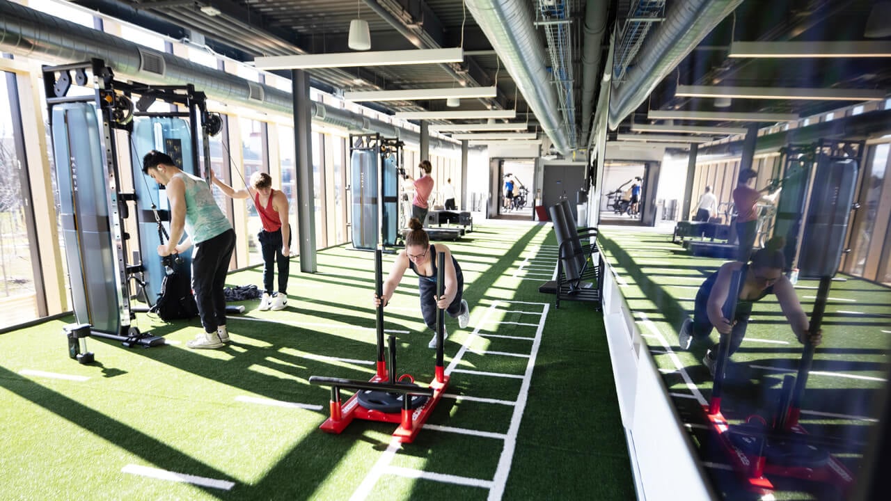 Students work out in the turfed functional training space