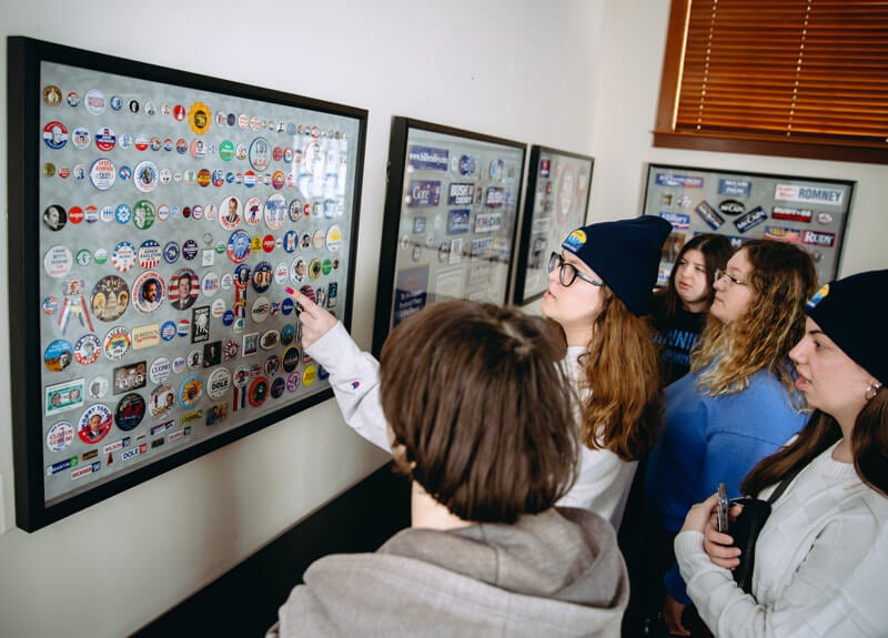 Quinnipiac students observe political memorabilia at the New Hampshire Institute of Politics.
