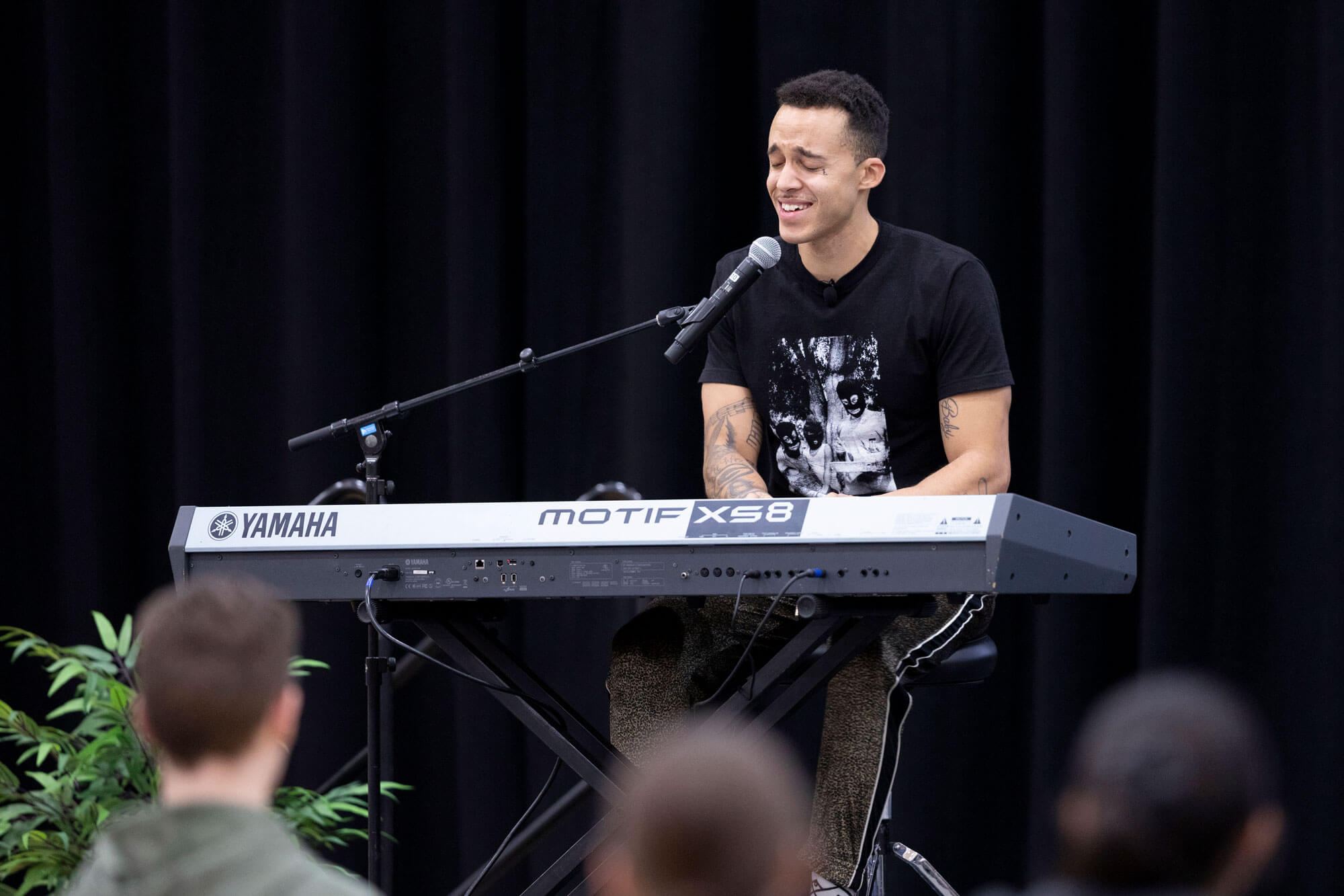 Richard Edmond-Vargas performs with a keyboard in front of an audience.