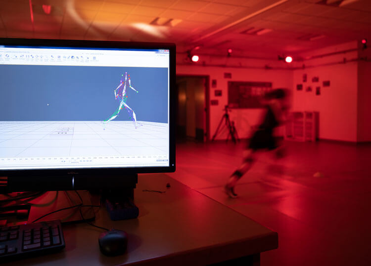 A student conducts testing in a motion analysis lab.
