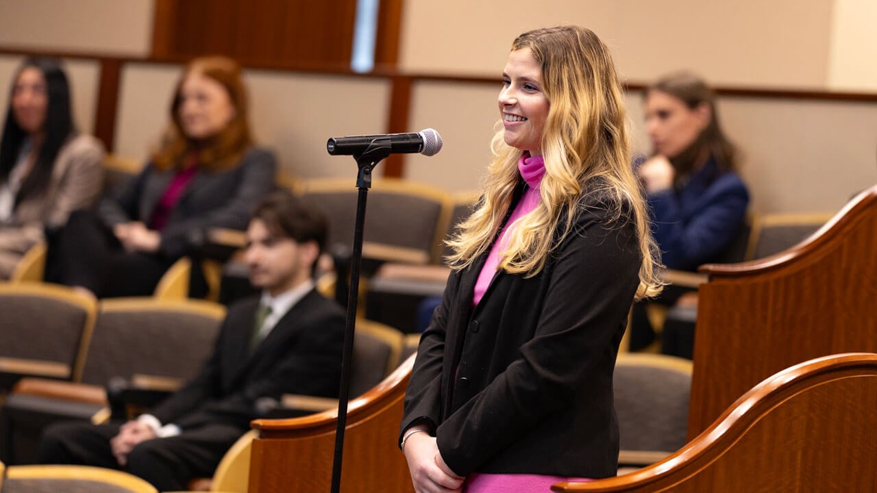 Crowd member talking into microphone