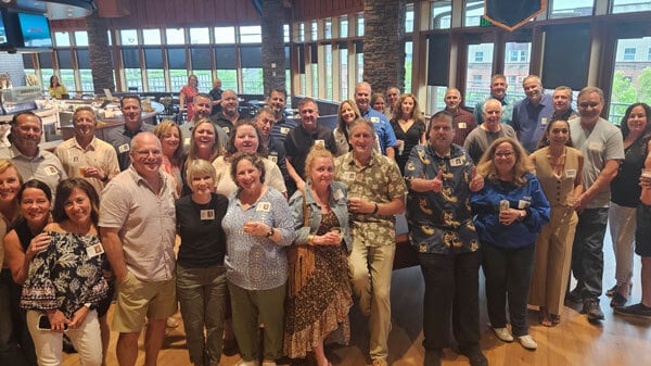 Quinnipiac alumnus Michael Fenster poses for a picture at On the Rocks Pub in the Rocky Top Student Center with members of the Class of 1990 for their 35-year reunion