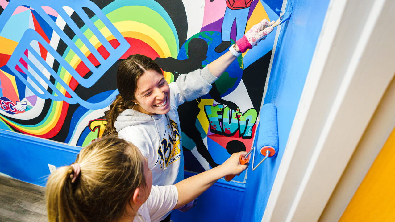 Students paint a wall