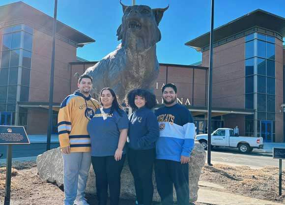 Sebastian, Lucas, Jade and Ashley Vacco in front of the bobcat statue on the York Hill Campus