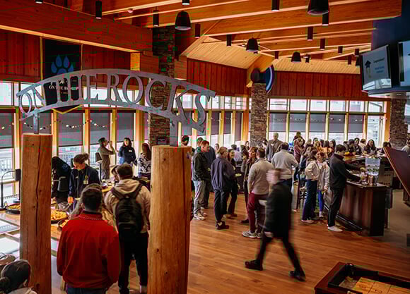 Students and patrons walking in the On The Rocks Pub and Grill
