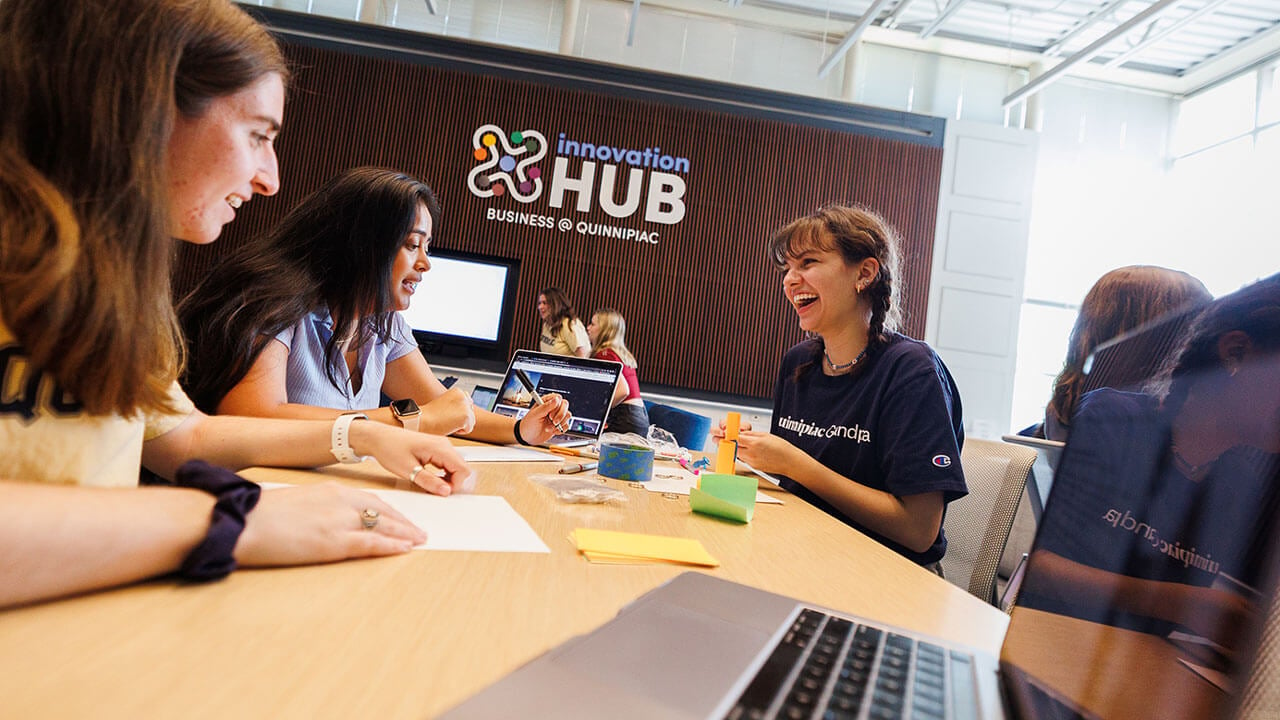 Students gather in the Innovation Hub to discuss and develop social enterprise and business ventures.