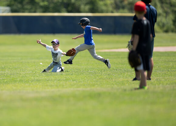 Children play baseball at the Quinnipiac baseball field