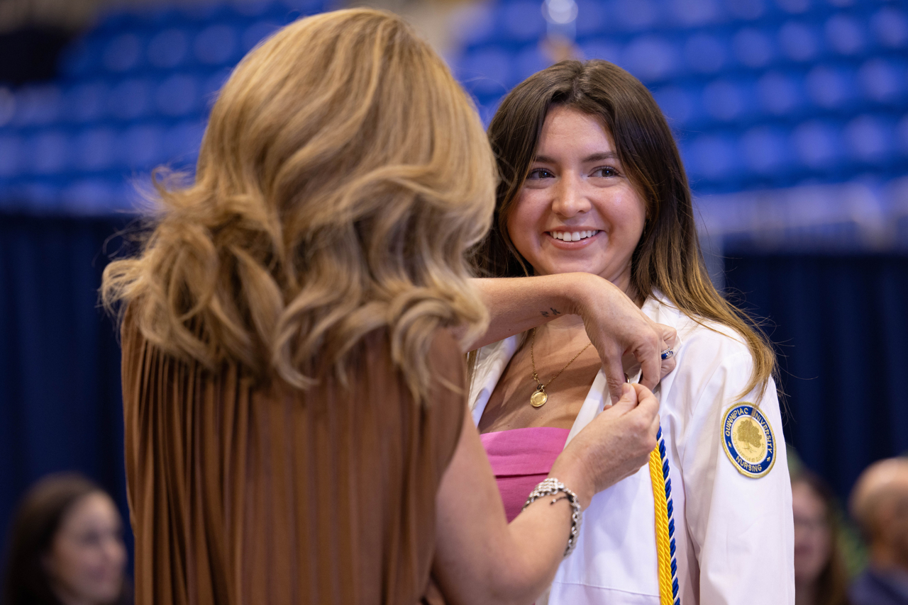 Nursing students smiles as they receive their pin