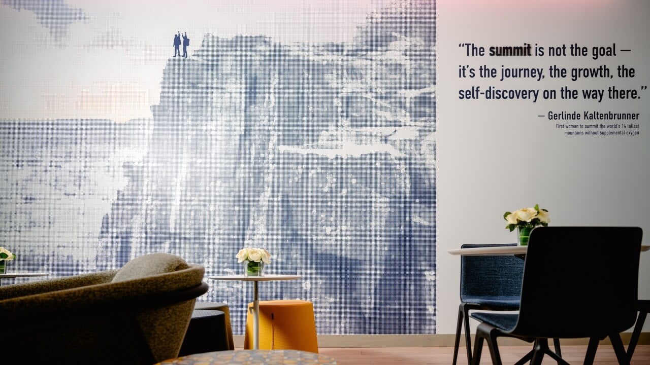 Wall décor in The Summit that showcases two people on top of a mountain