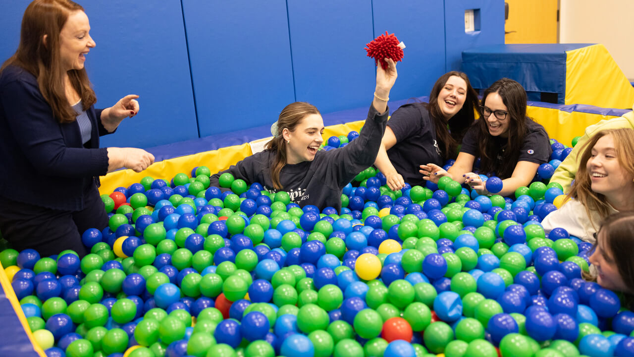 Occupational Therapy students play in a ball pit