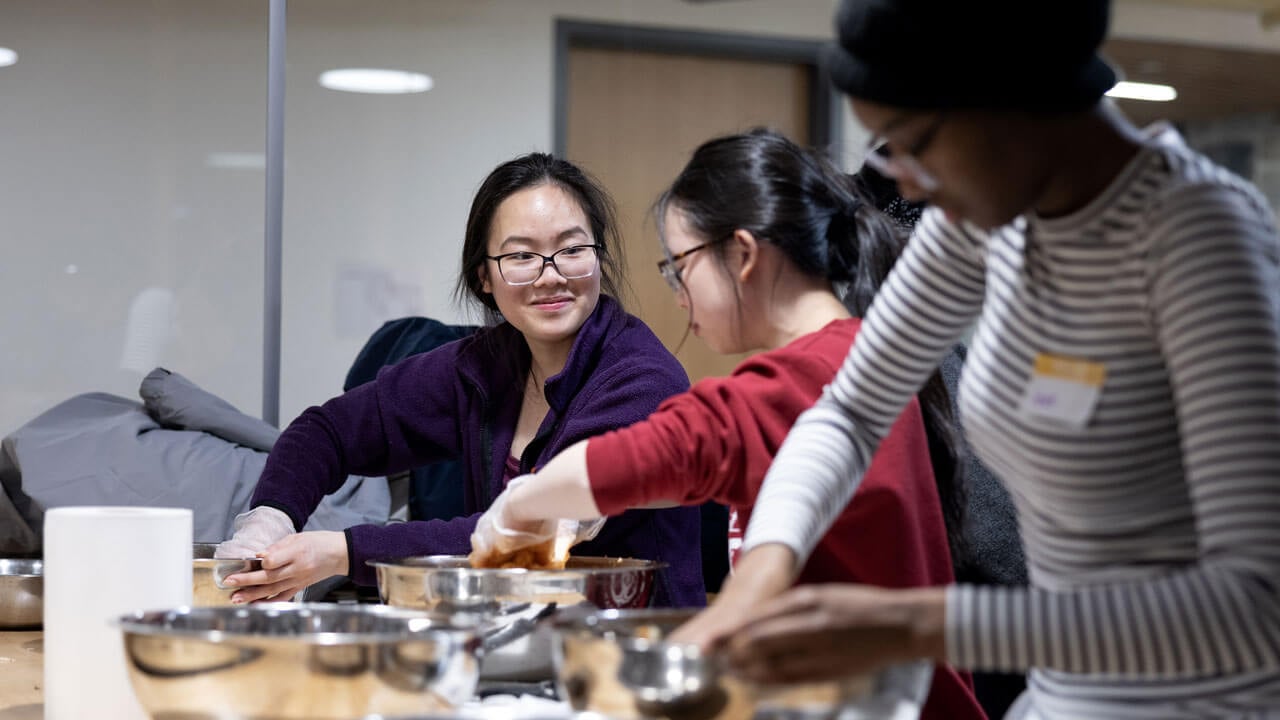 Students cooking kimchi during a RecWell session