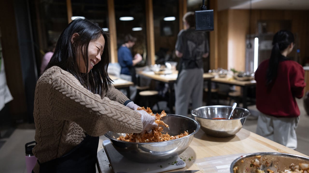 Student takes part in kimchi preparation at RecWell