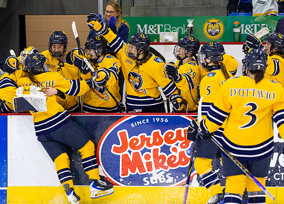 Women's ice hockey celebrates a goal