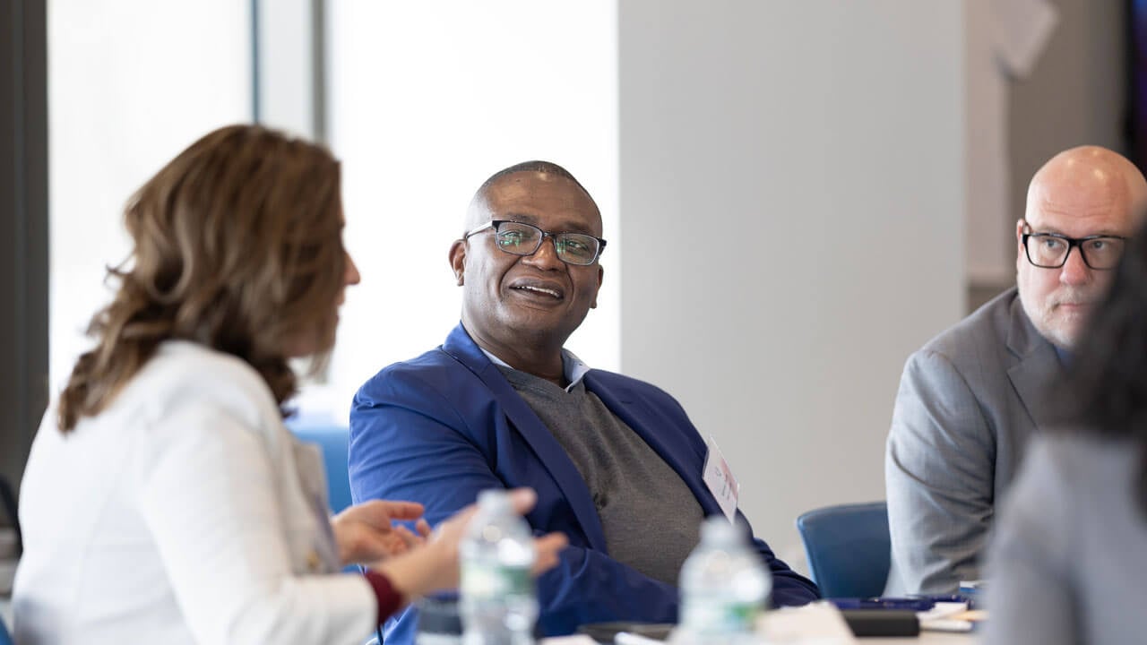 Yale School of Management Dean Kerwin Charles looks toward Dean Holly Raider