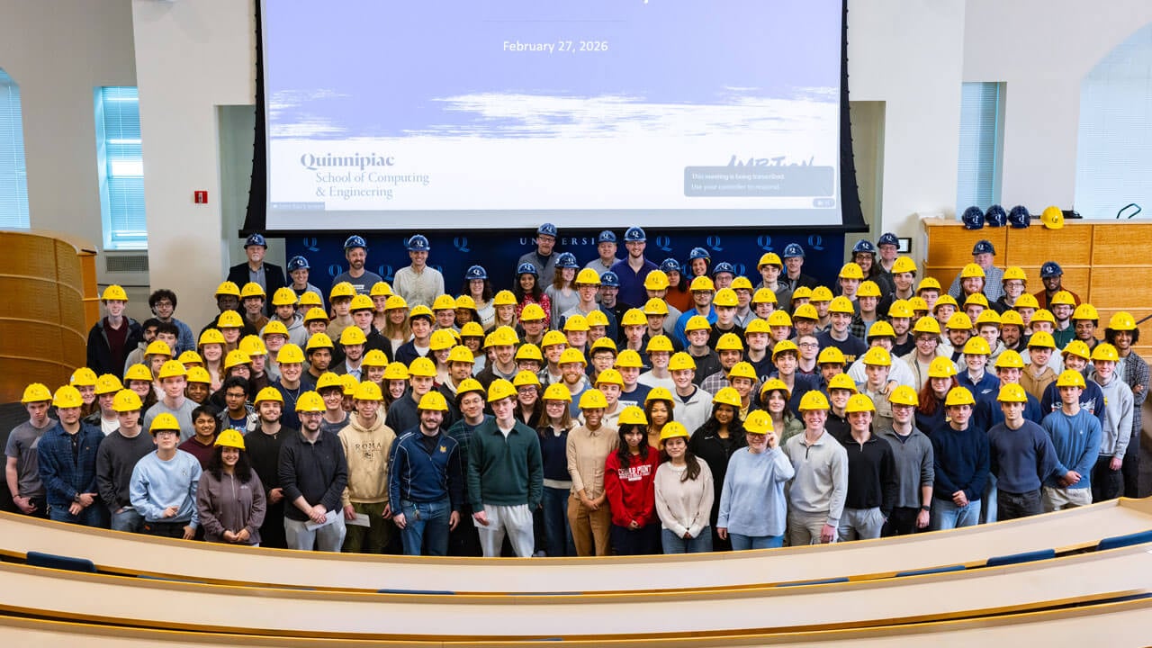 All engineering students pose with hard hat