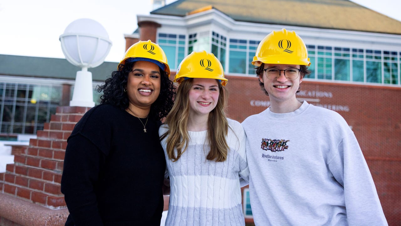 Students pose with hard hats