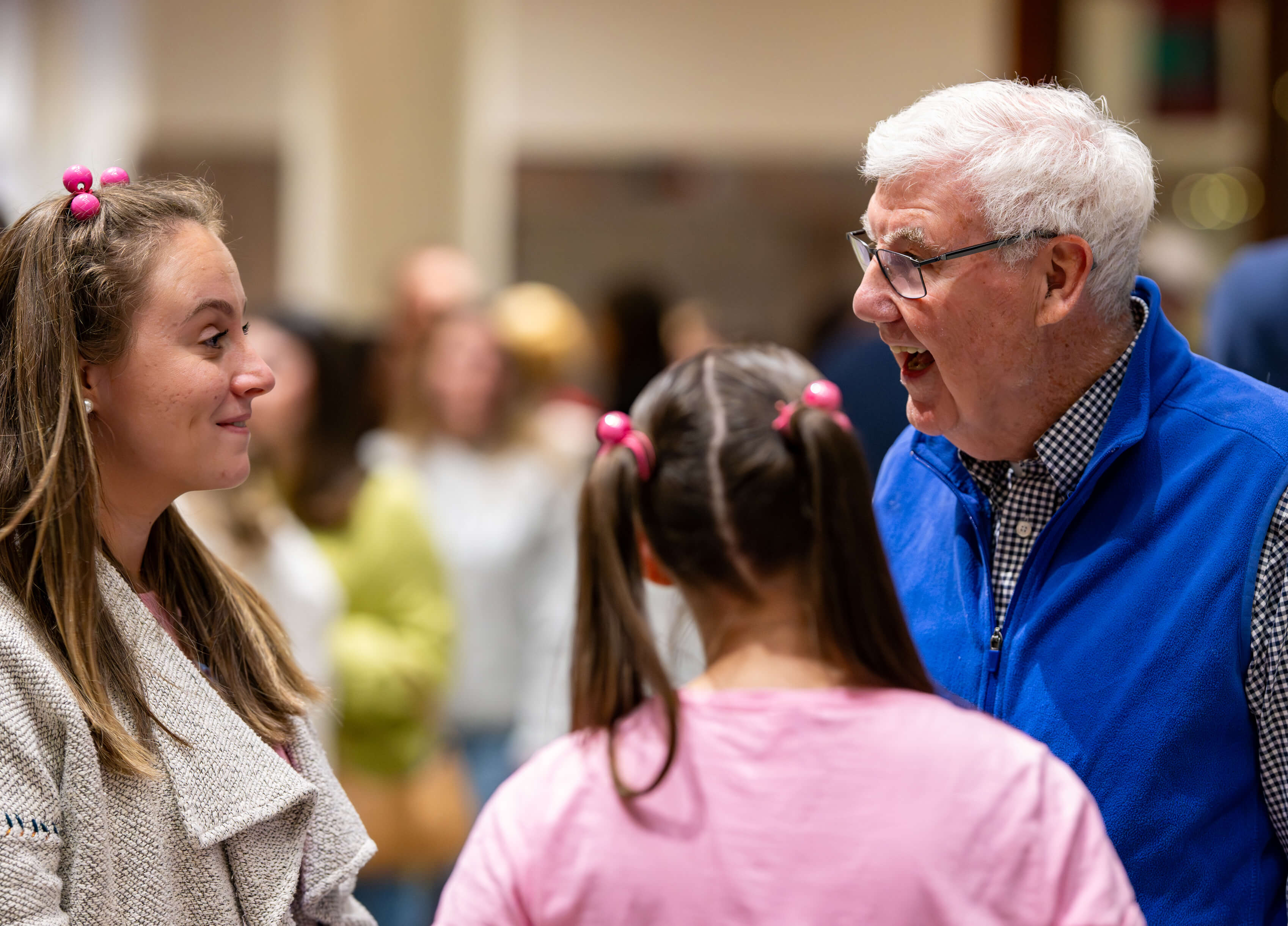 A group chats at the PILP Auction