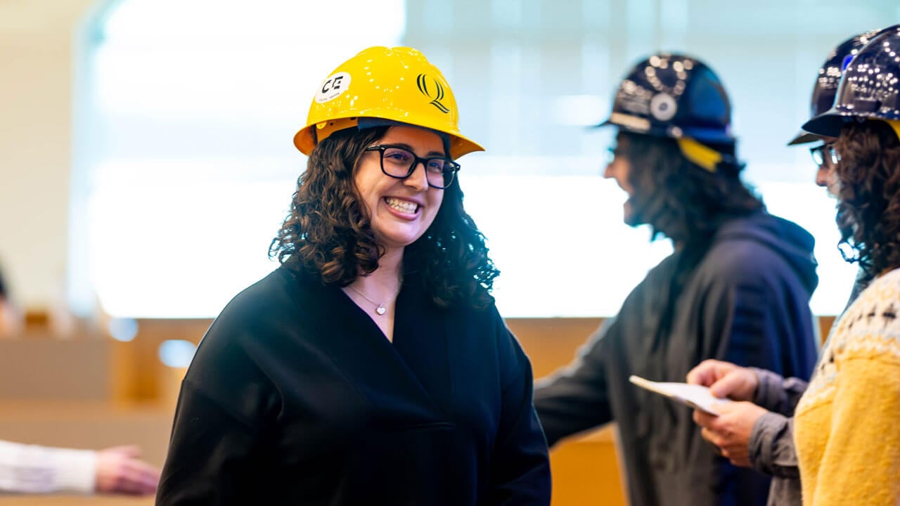 Student smiles while receiving hard hat
