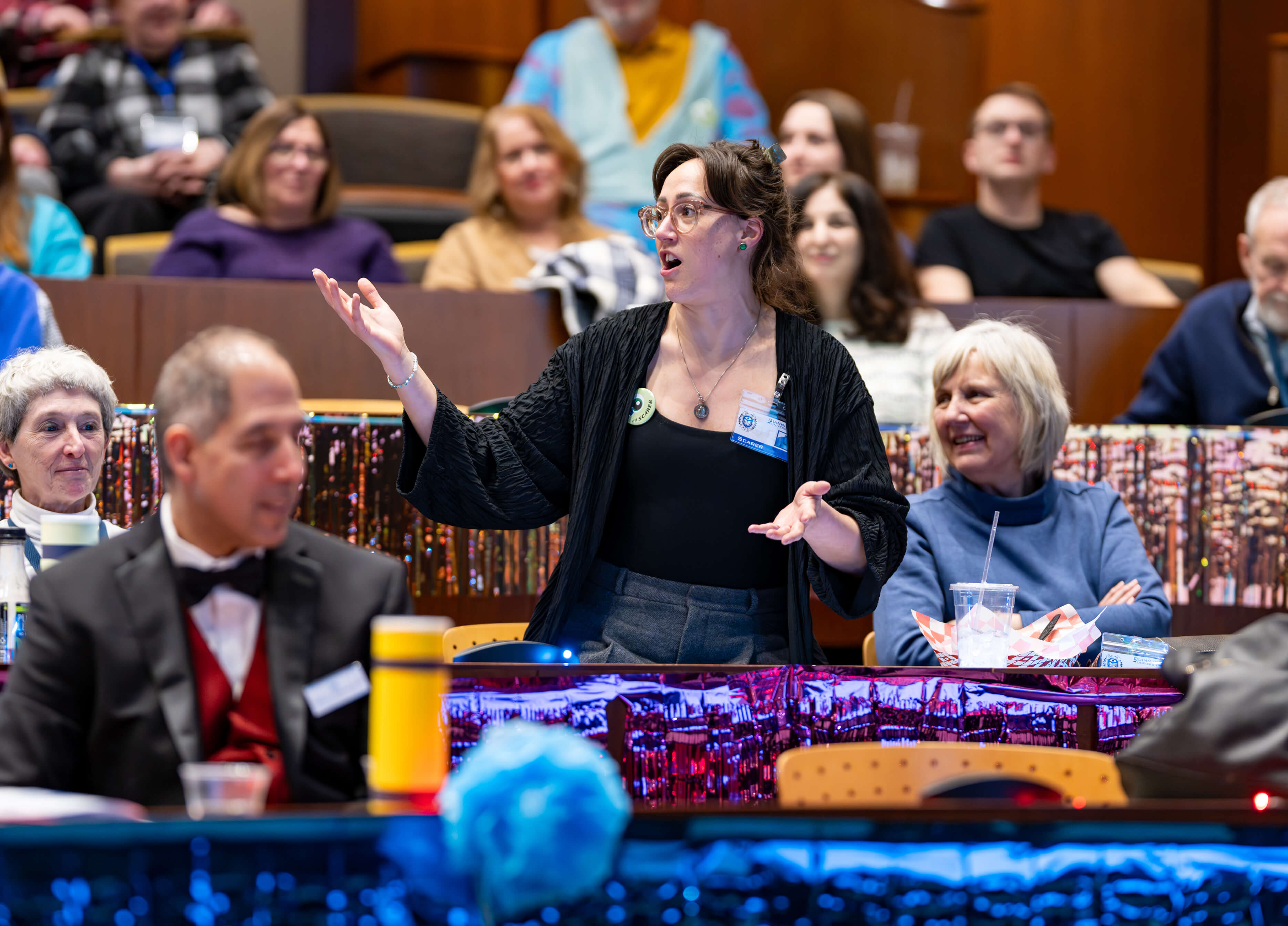 Individual stands up at 33rd Annual PILP Auction