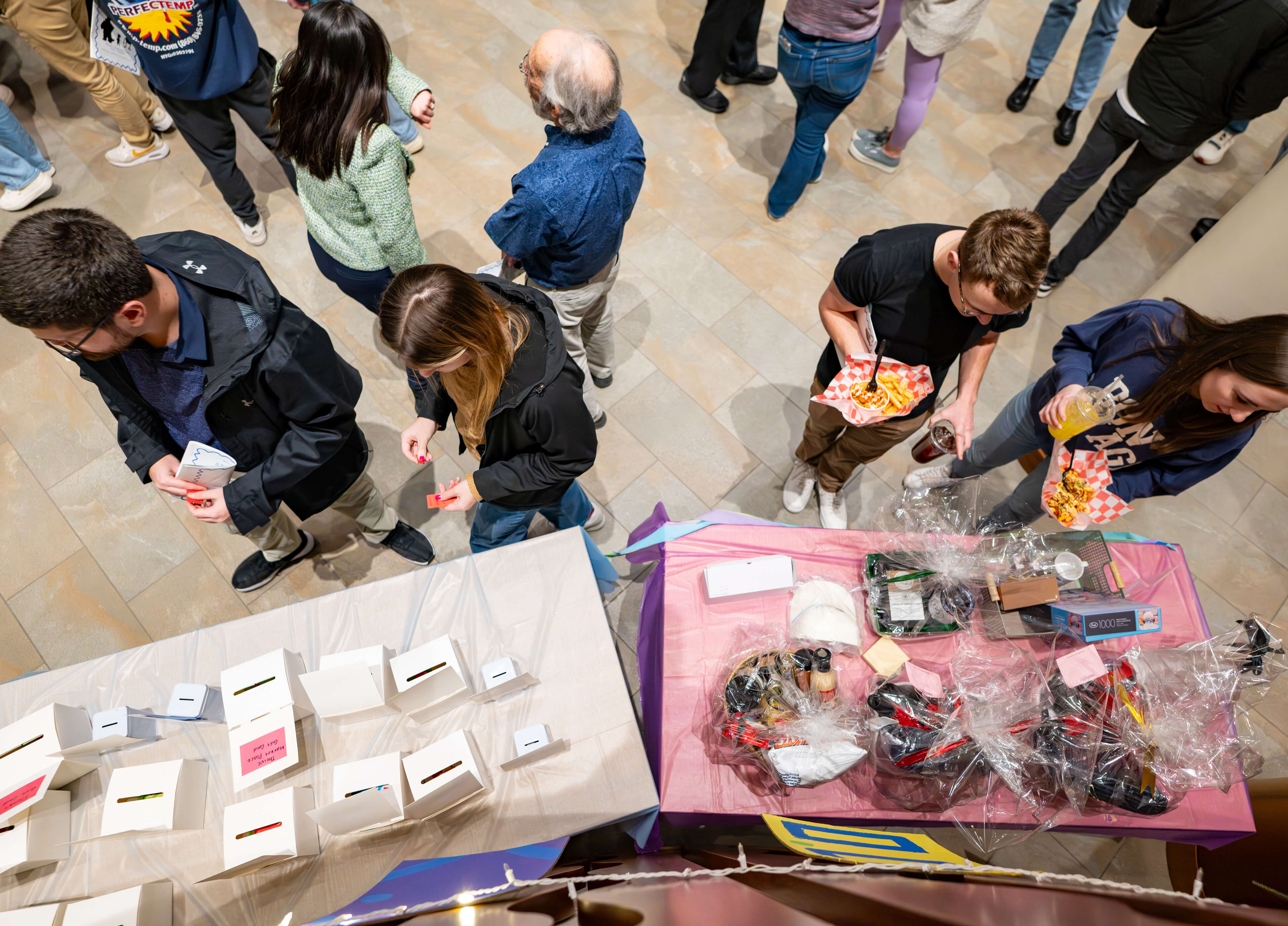Individuals check out tables at the PILP Auction