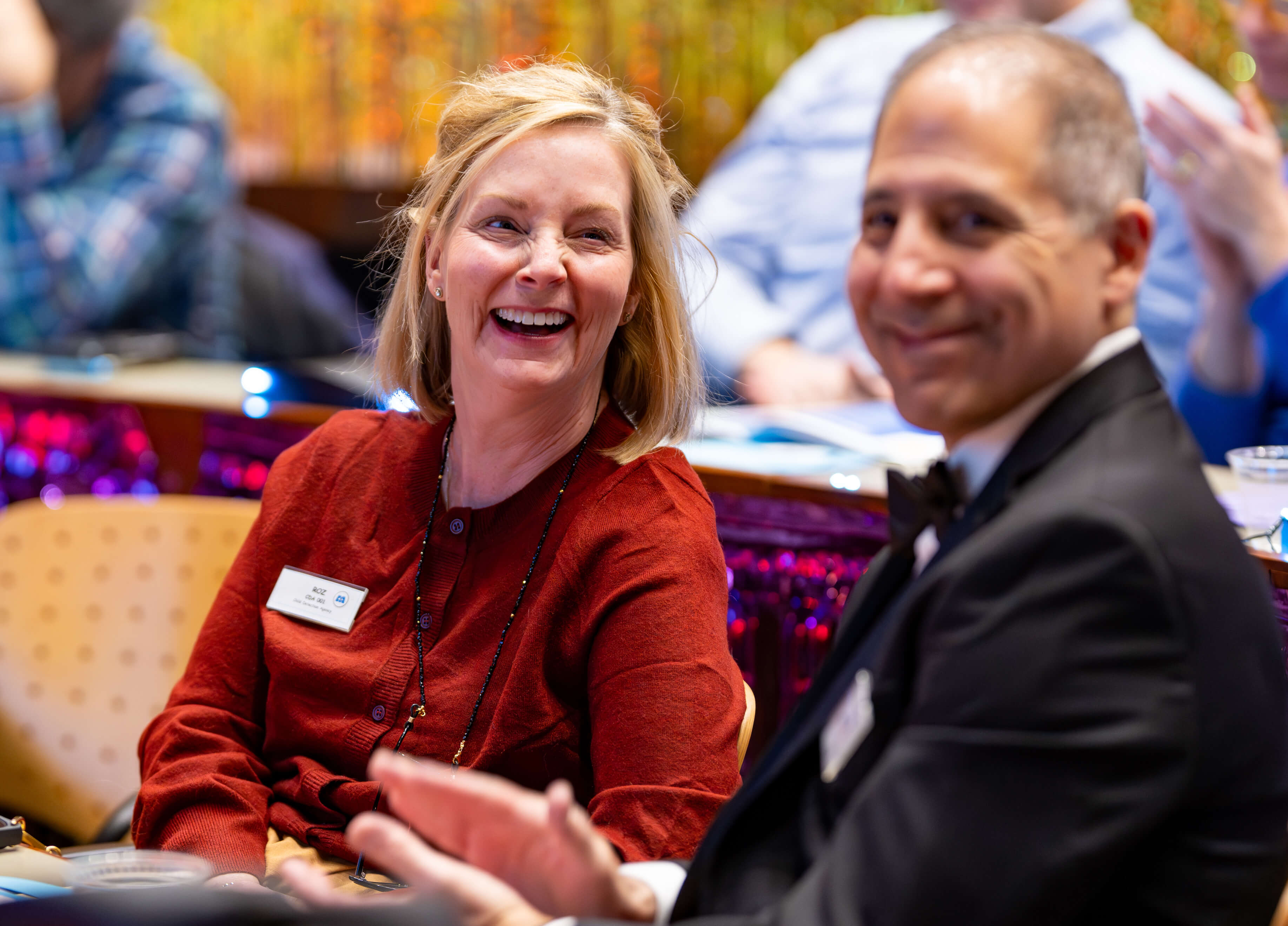 Two individuals smile together at the 33rd Annual PILP Auction