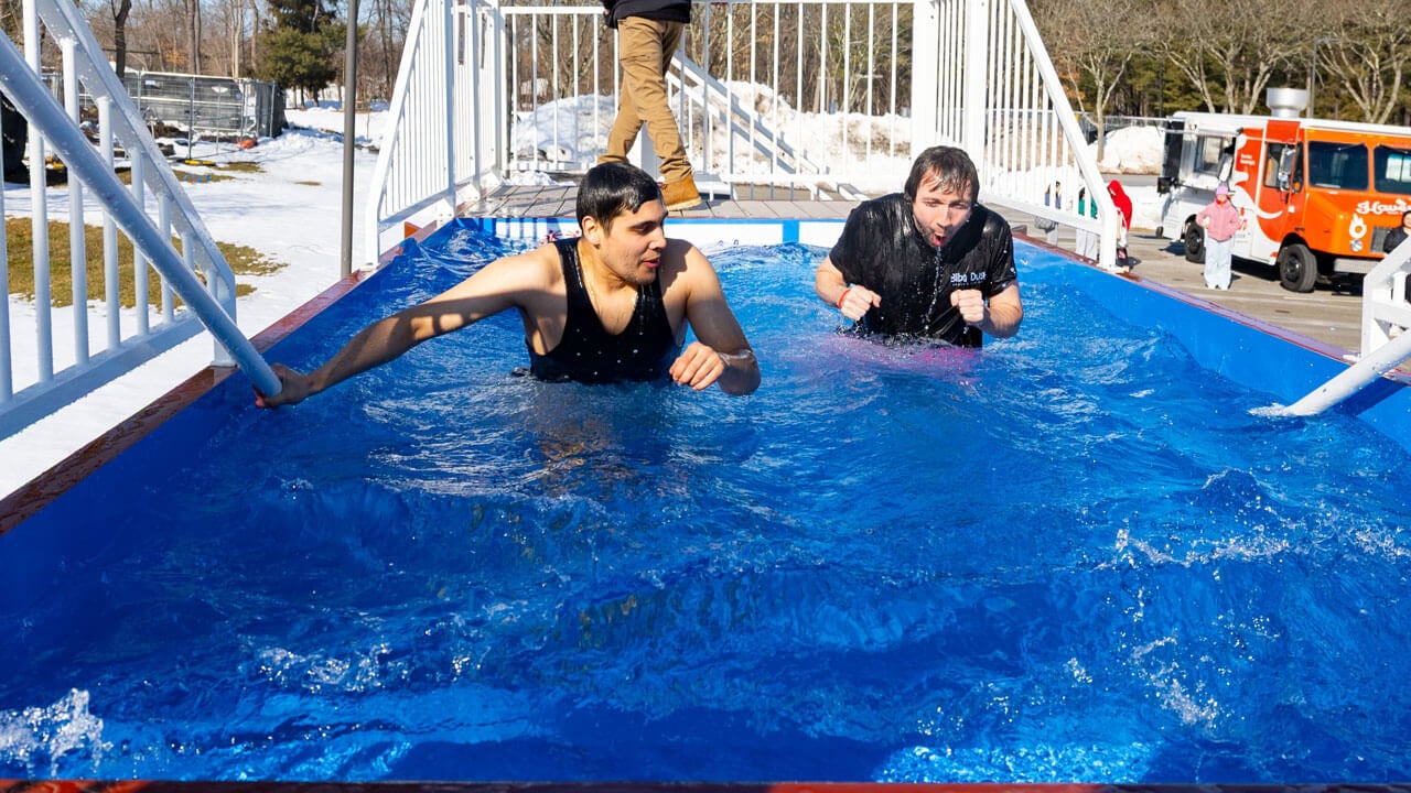 Students and participants stand in freezing dunk tank
