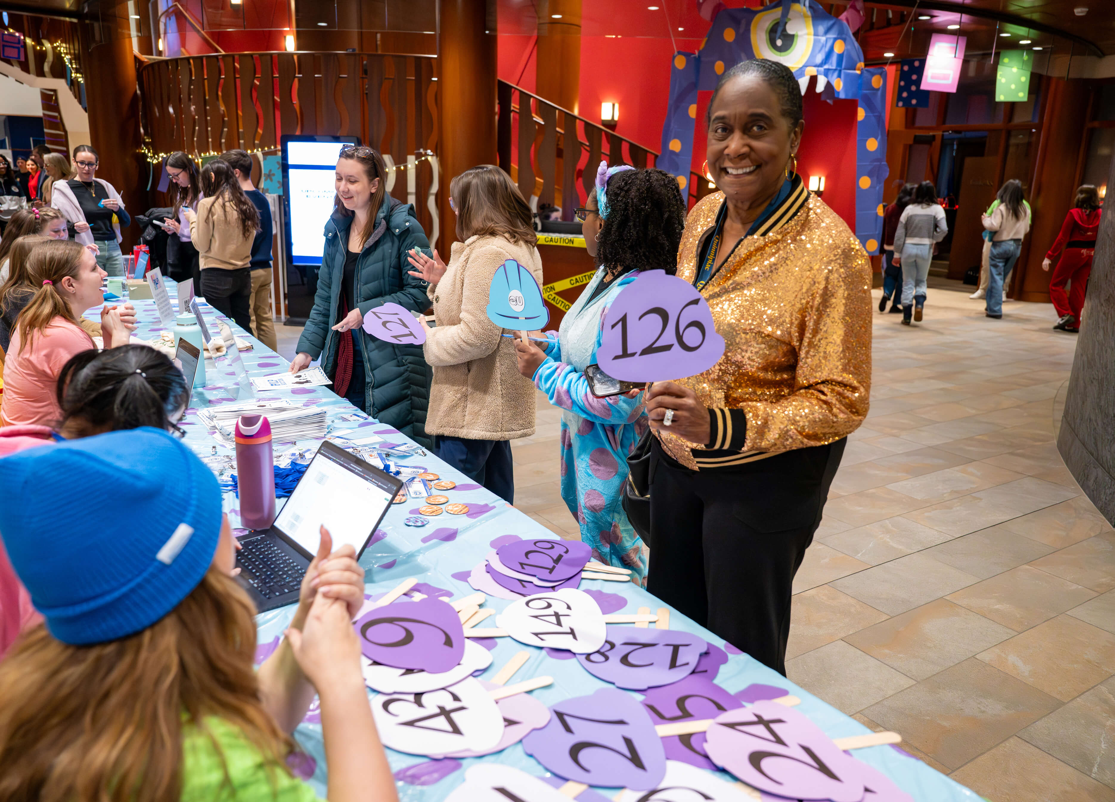 Individual holds up number at the PILP Auction