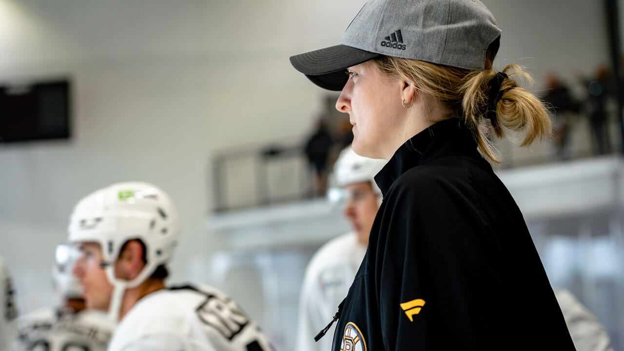 QU alumnus Danielle Marmer looks on during a Boston Bruins training camp drill. (photo courtesy of Steve Babineau / Boston Bruins)