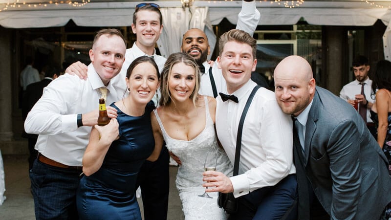 Group of 6 smiling and posing in wedding party