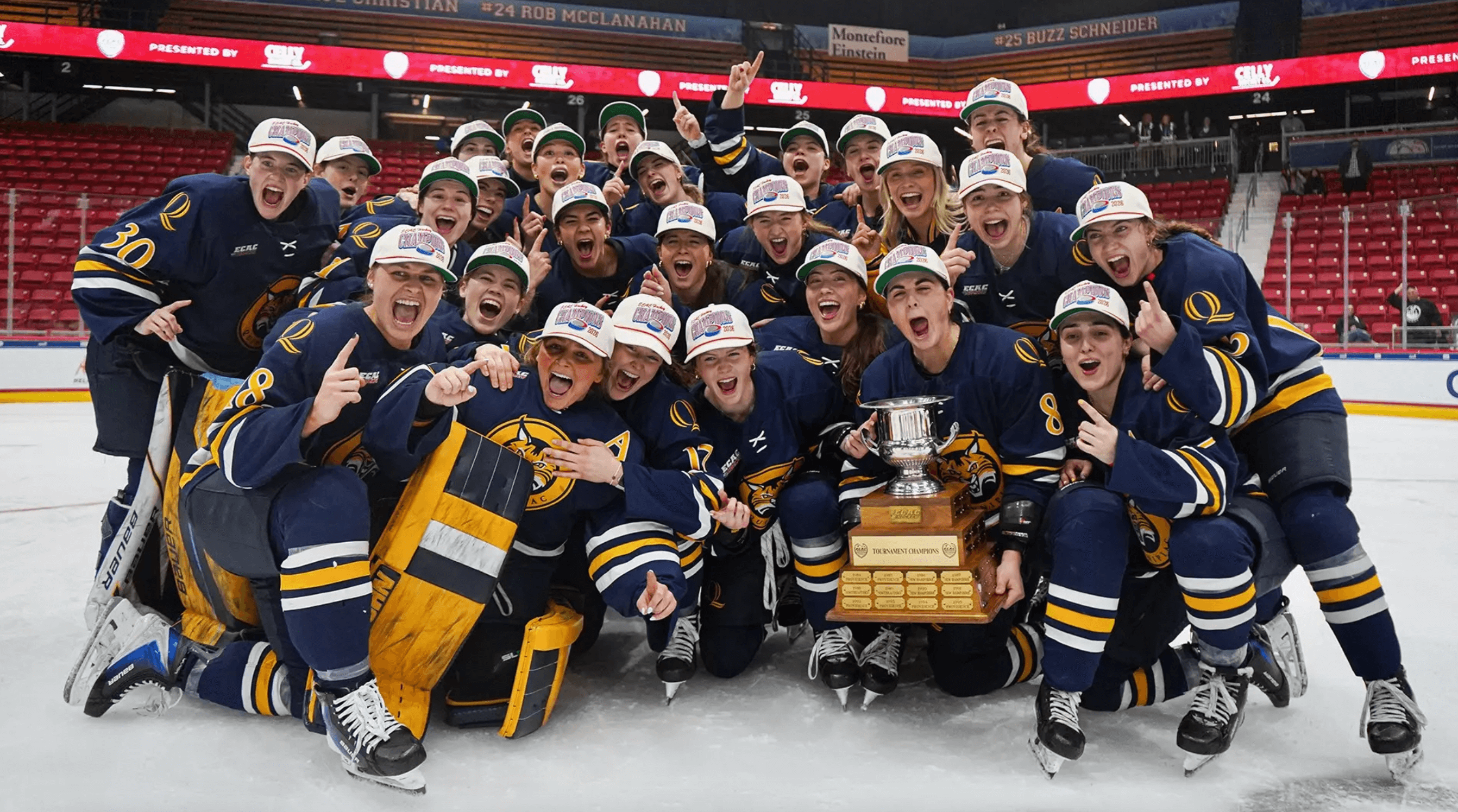 Quinnipiac women's ice hockey with the ECAC Championship trophy on the ice in Lake Placid.
