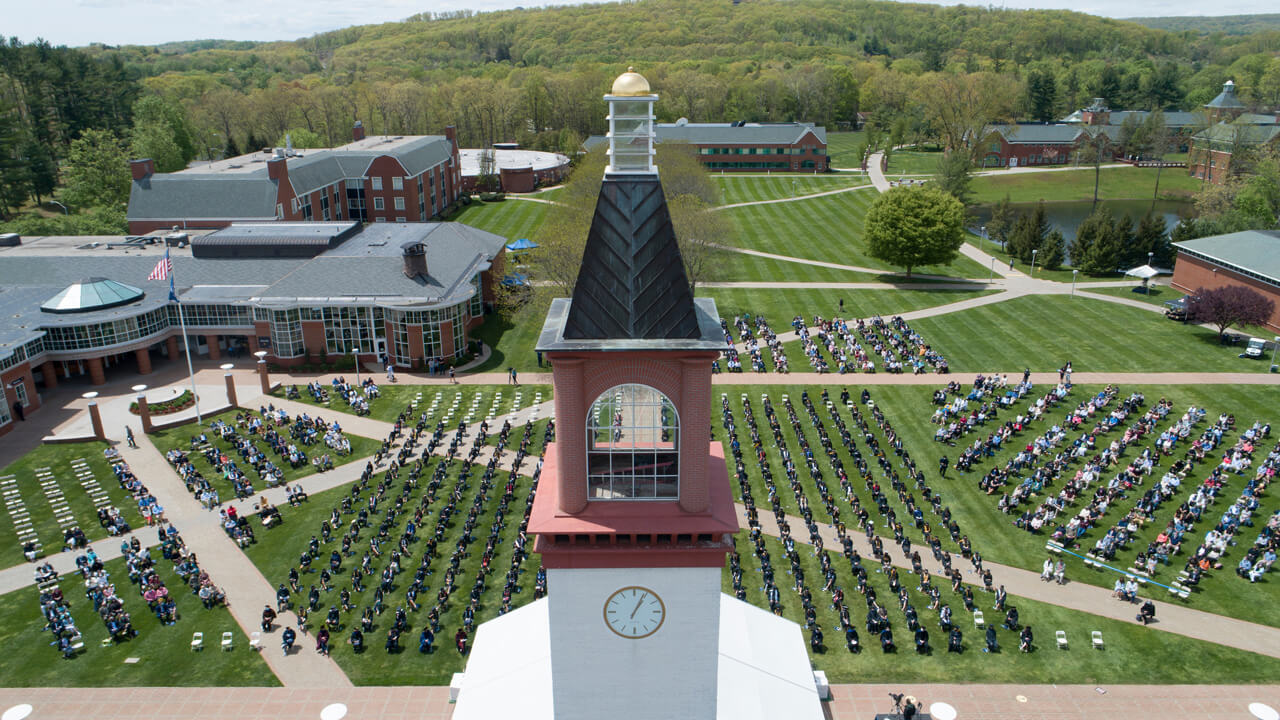 Aerial view of the library clocktower and quad during a Commencement ceremony