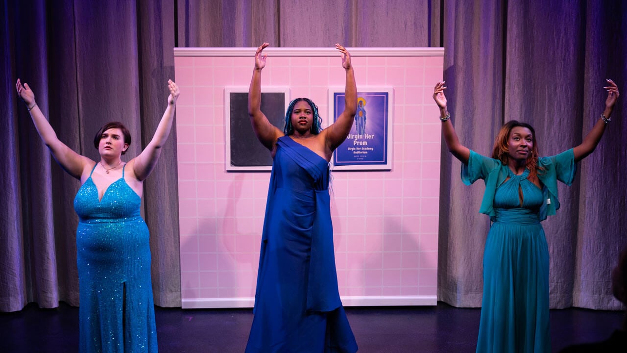 Quinnipiac students raising their hands in the air acting in the spring play