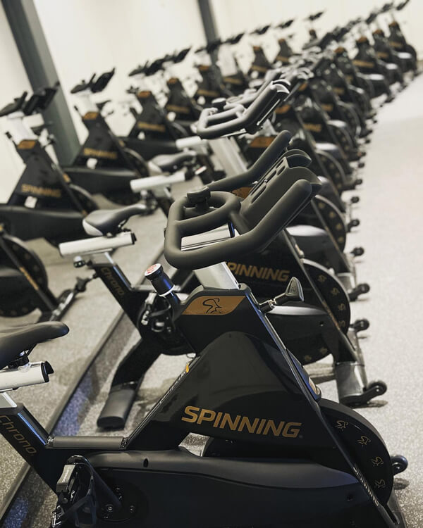Two rows of brand new Spinning bikes in the Rec and Wellness Center