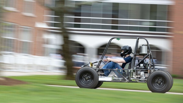 Student driving a single-seat recreational vehicle