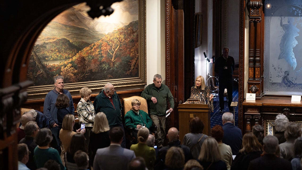 Community members gathering around President Marie Hardin as she speaks in the Ireland Great Hunger Museum