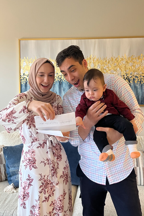 Salam Taraben and her family smile as they open her Match Day envelope in their home