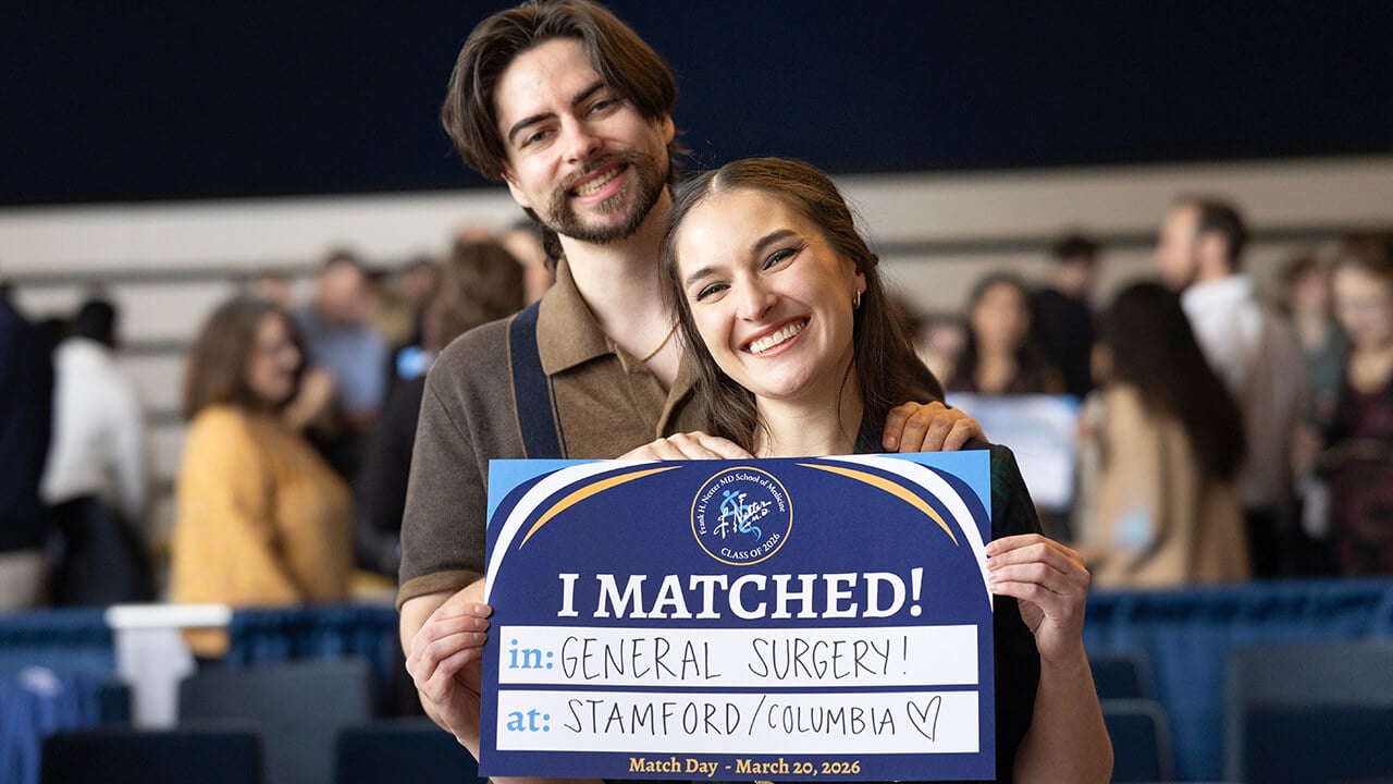 Student holding up their match sign on Match Day 2026