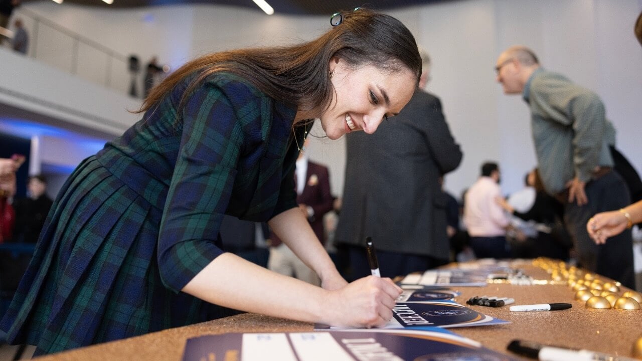 A student writing down their match on match day