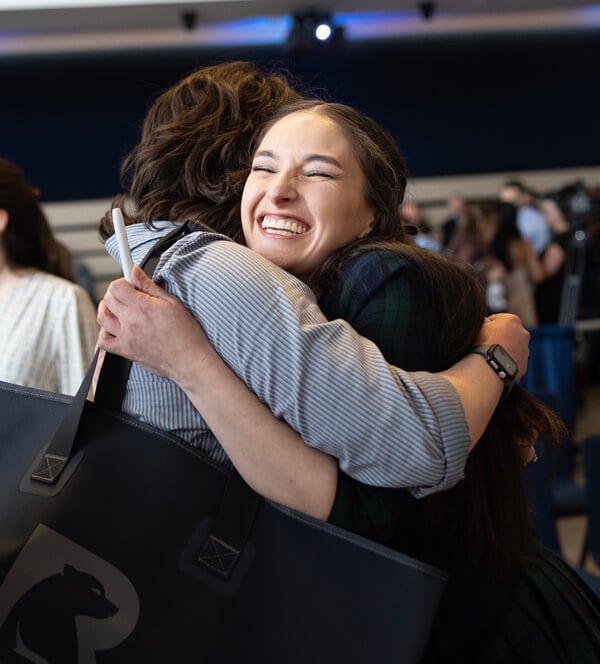 Paulina Naser-Saravia smiles broadly and hugs a loved one during Match Day