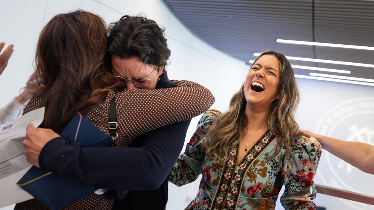 Lucas Cordova emotionally hugs a loved one while Megan Cortes exclaims next to him