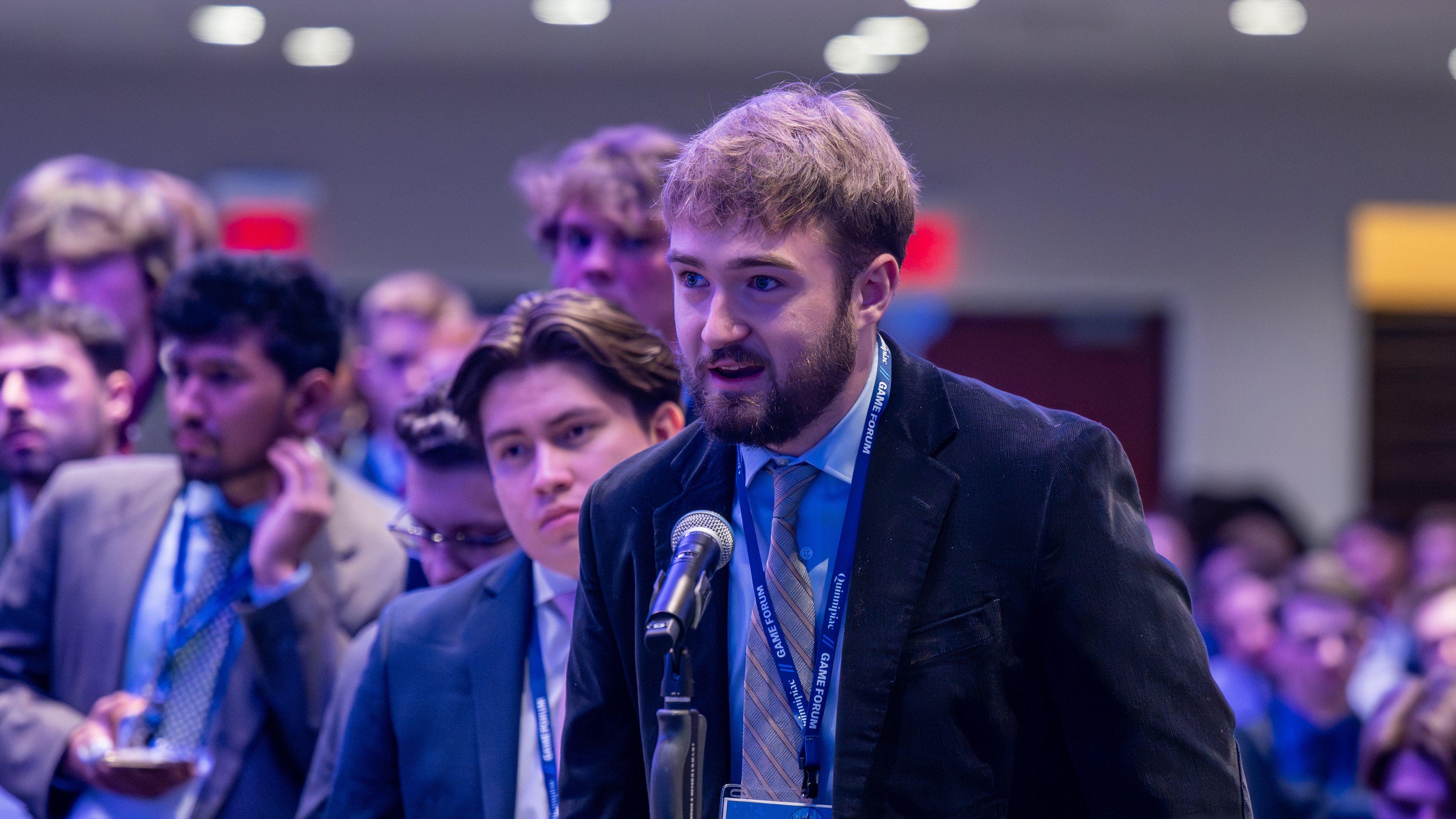 Individual speaks into microphone at 15th annual Global Asset Management Education Forum in New York