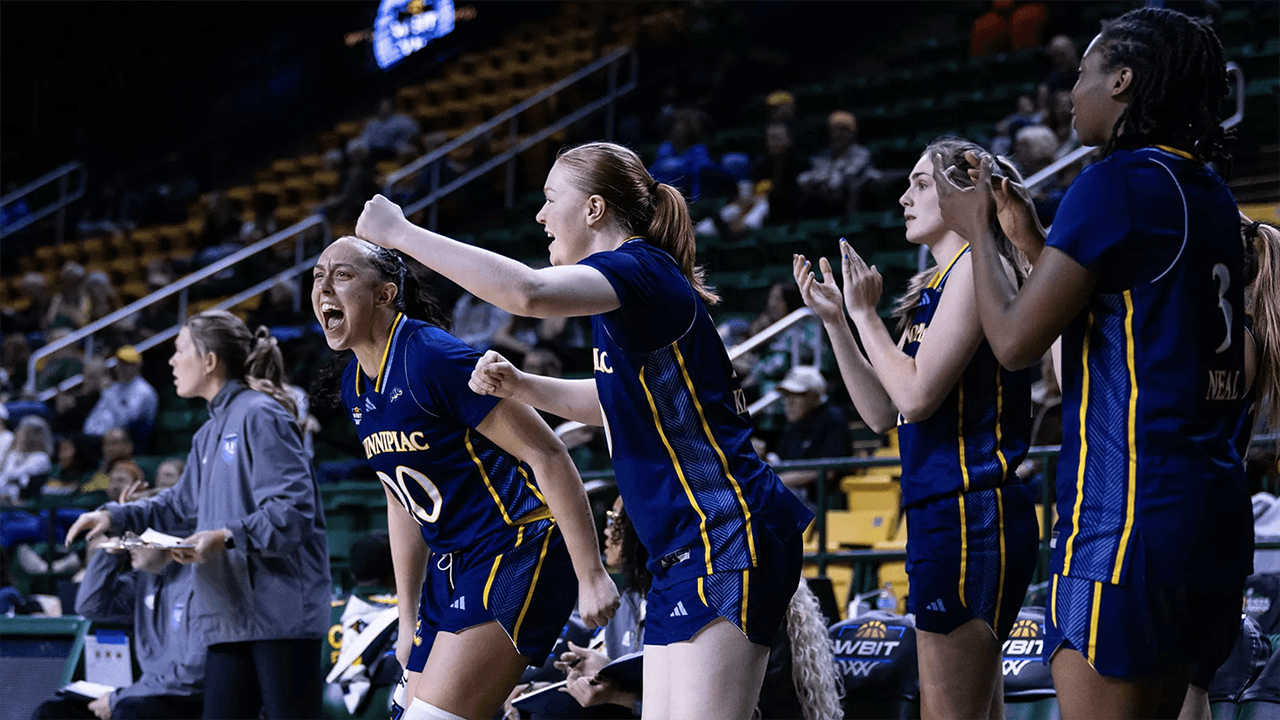 Women's Basketball players celebrating after winning the first round of the WBIT