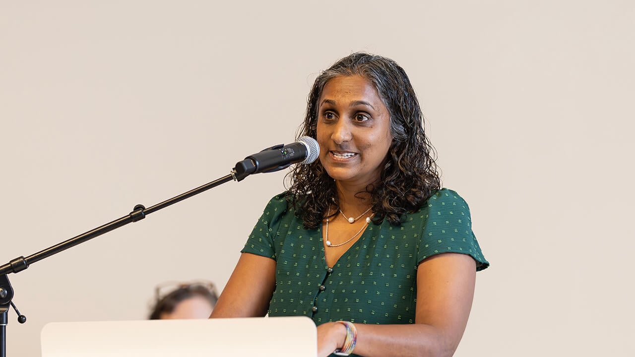 Person speaking to medical students before opening their Matches