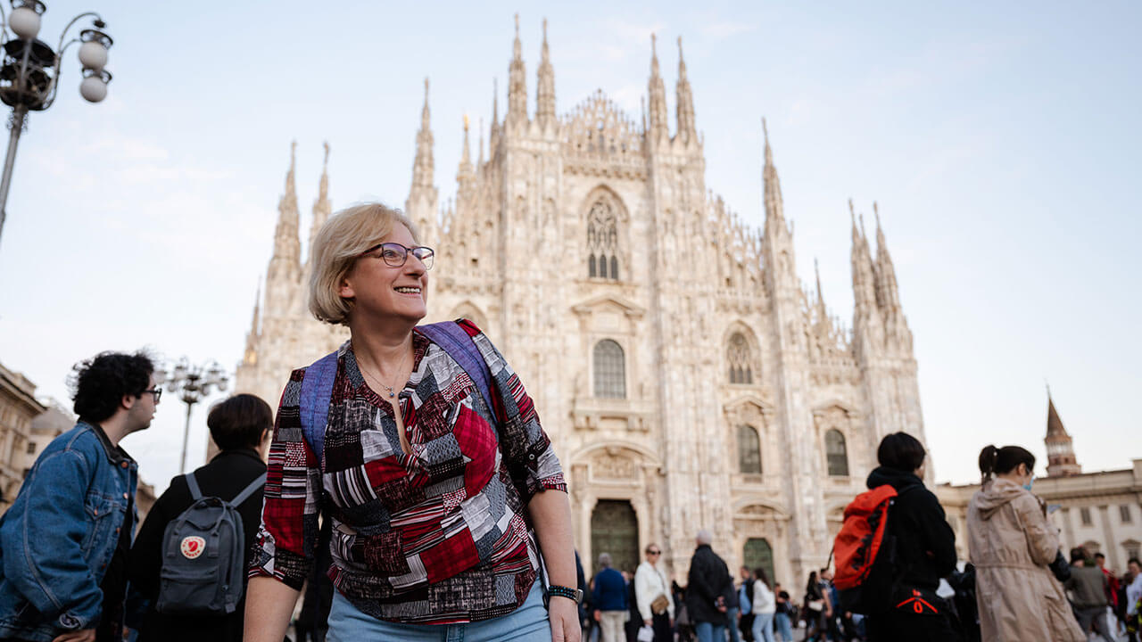Professor takes photo in front of the Duomo in Milan
