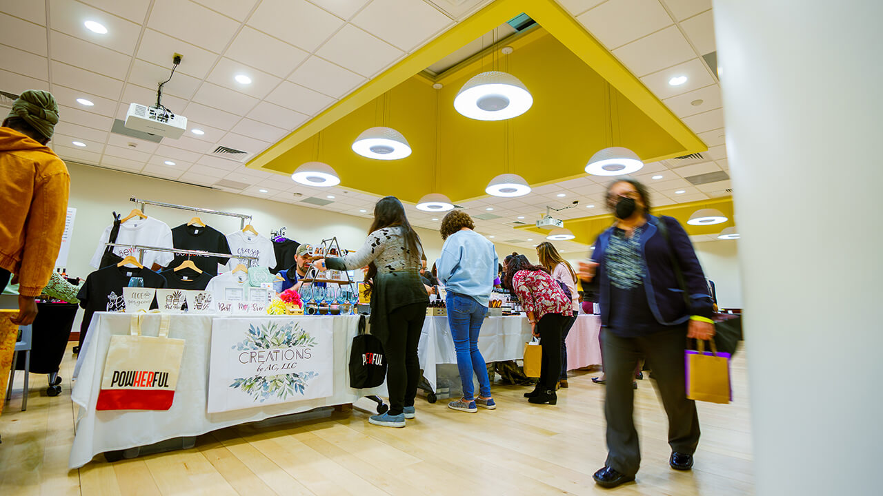 Wide view of small businesses selling their products at tables