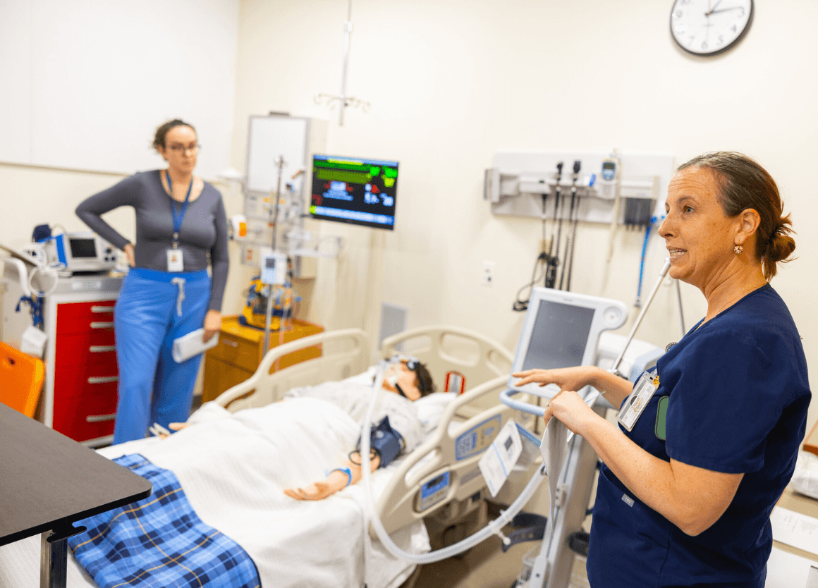 nursing instructor explaining clinical skills in simulation lab