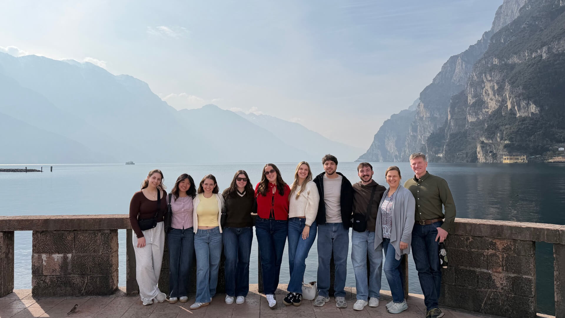 Students on Trentino trip pose in front of a mountainous background