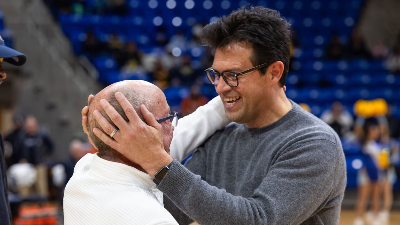 Two men talking on the basketball court
